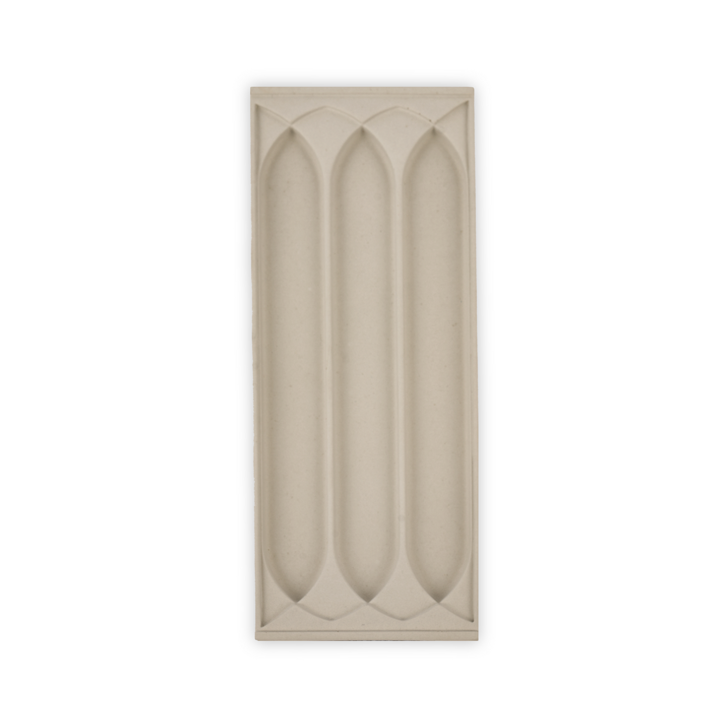 A stone tray with a three gothic arch patterns for putting writing supplies in.