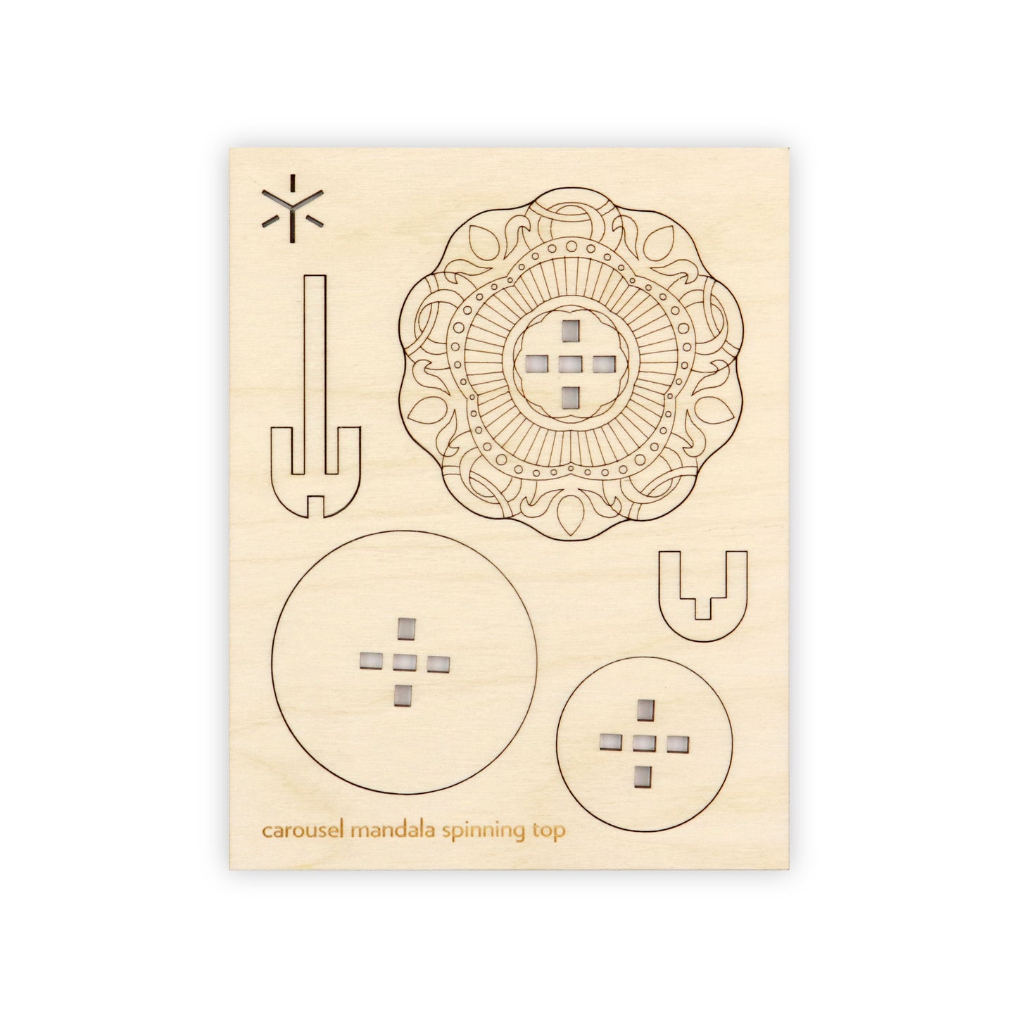 A flat wooden board with several removable shapes cut into it. On the bottom of the wooden board is written in yellow "peacock mandala spinning top".