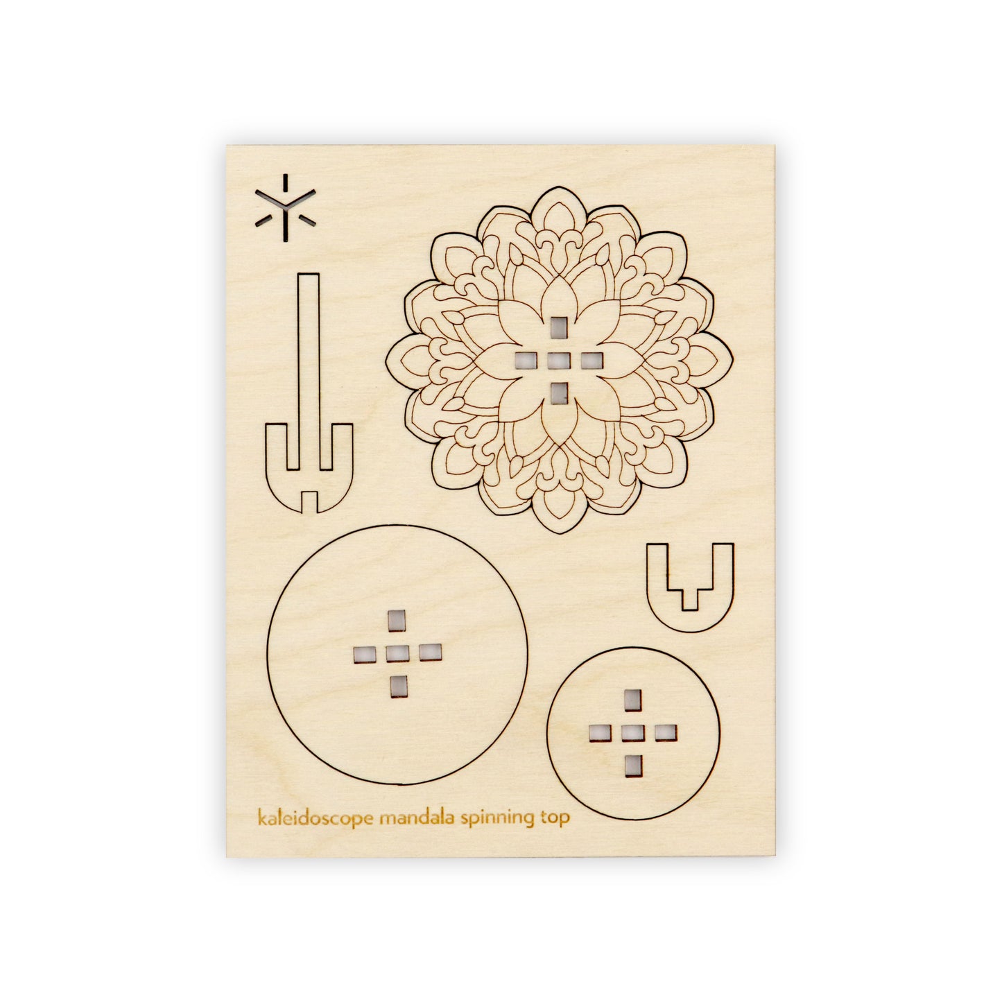 A flat wooden board with several removable shapes cut into it. On the bottom of the wooden board is written in yellow "peacock mandala spinning top".